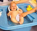 Baby in blue bath tub.